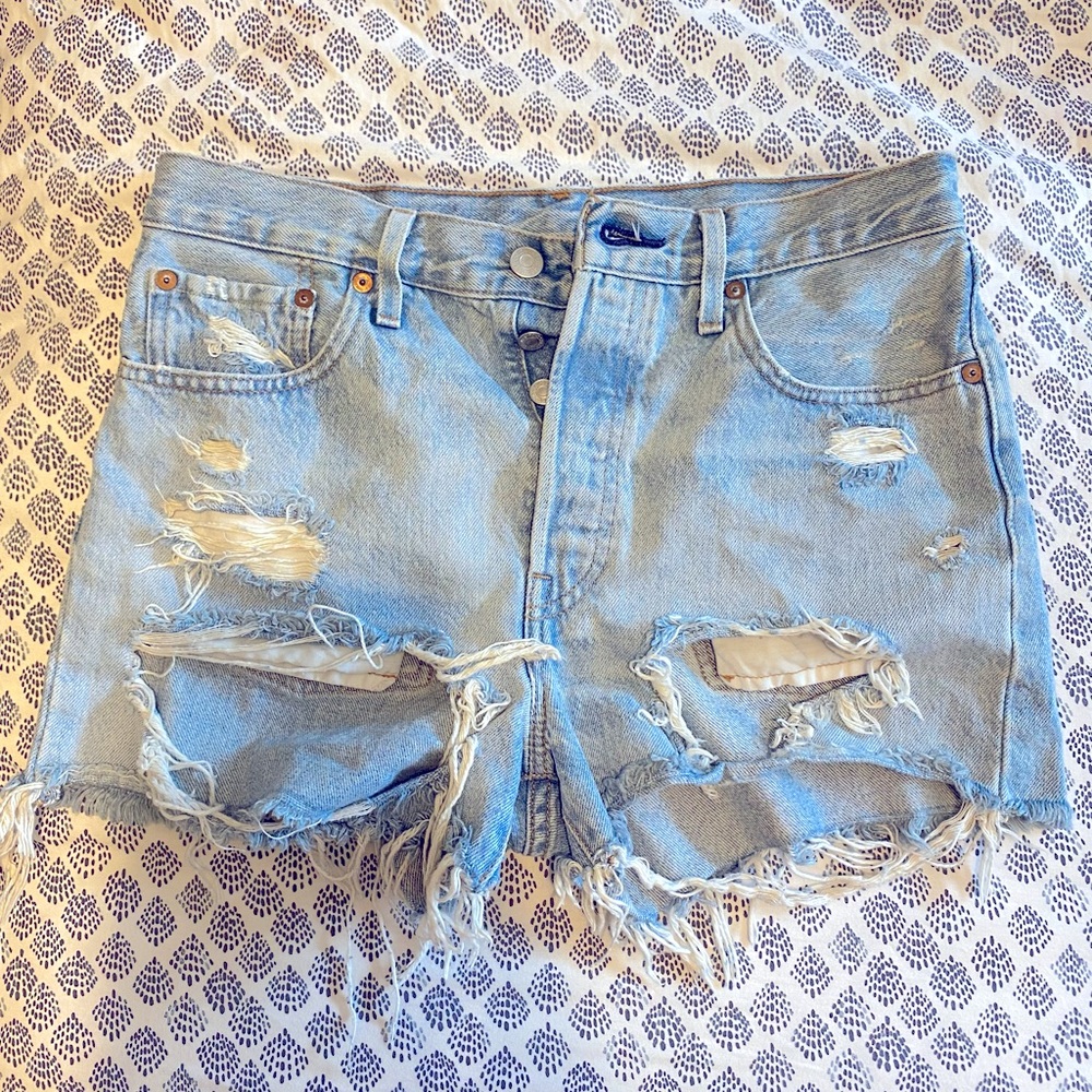 Levi heavily distressed light wash jean shorts size 27